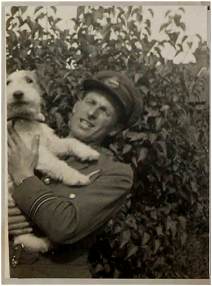 Navigator F/Lt. George Newsham - DFC - with his dog 'Joe'